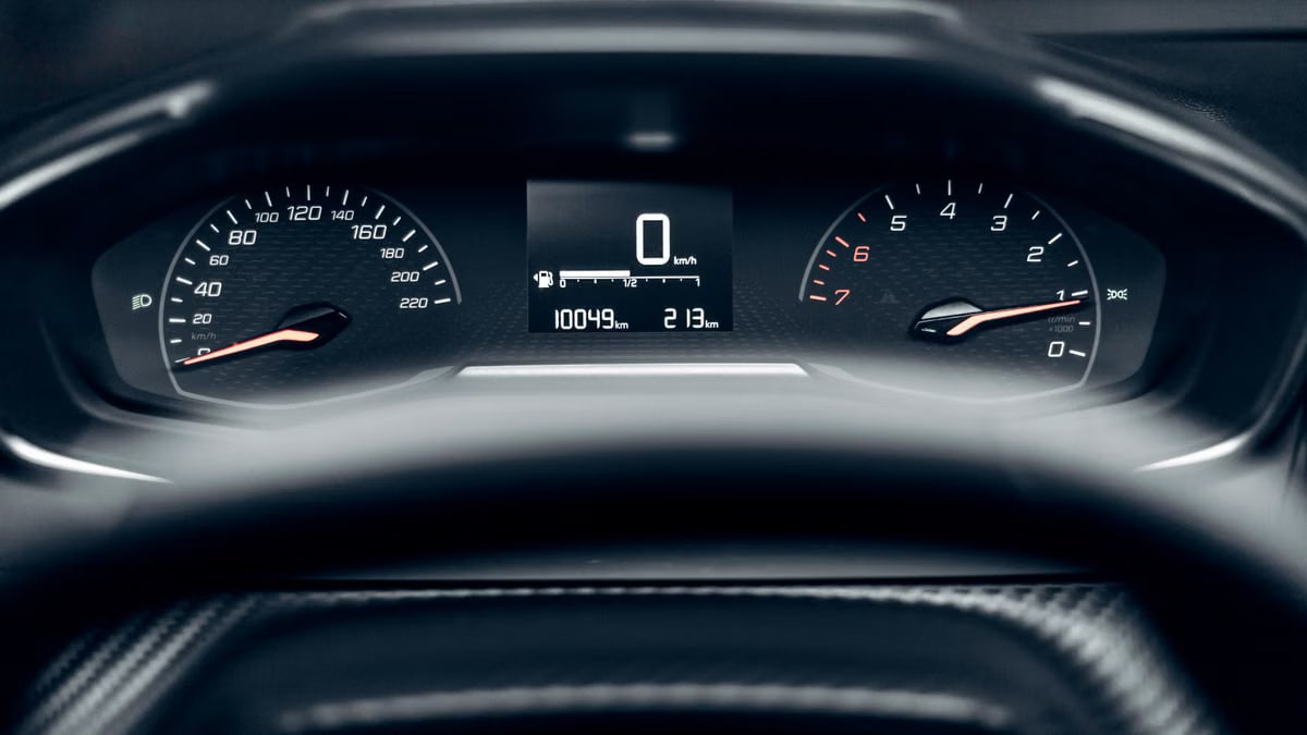 Detailed view of a modern car dashboard showing speedometer, odometer, and tachometer.